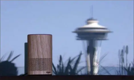  ?? ASSOCIATED PRESS FILE PHOTOS ?? An Amazon Echo device sits on a balcony outside an Amazon office as the Space Needle is reflected in windows behind it following a program announcing several new Amazon products by the company, in Seattle. Amazon says an “unlikely” string of events...