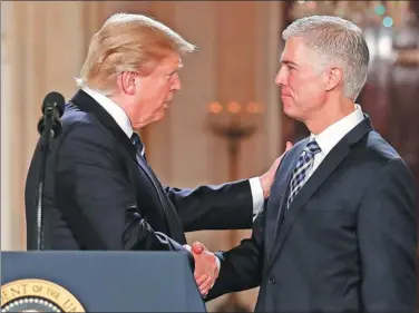  ?? AP ?? US President Donald Trump shakes hands with 10th US Circuit Court of Appeals Judge Neil Gorsuch, his choice for Supreme Court associate justice, in the East Room of the White House in Washington, on Tuesday.