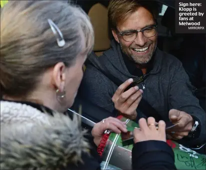  ??  ?? Sign here: Klopp is greeted by fans at Melwood
MIRRORPIX