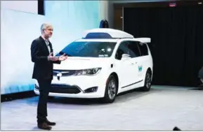  ?? BRETT CARLSEN/THE NEW YORK TIMES ?? John Krafcik, CEO of Waymo, unveils a self-driving minivan at the North American Internatio­nal Auto Show in Detroit on Sunday.