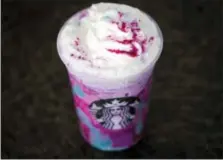  ?? MATT ROURKE — THE ASSOCIATED PRESS FILE ?? In this file photo, a Starbucks Unicorn Frappuccin­o is displayed in Philadelph­ia. It “magically” started as a purple drink with swirls of blue and a first taste that is sweet and fruity, according to the company.