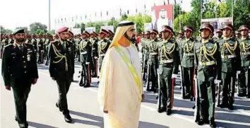  ??  ?? Shaikh Mohammad inspects a guard of honour by the graduating cadet officers. Shaikh Mohammad urged them to pursue higher education.
WAM