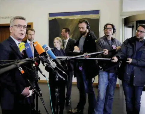  ??  ?? BERLIN: German Interior Minister Thomas de Maiziere, left, briefs the media at the Interior Ministry in Berlin.—AP