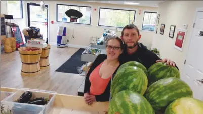  ?? Photo by Russ Olivo ?? Nicole Lussier and fiancé Michael Roy are pictured together in their store, East Side Produce, located at 562 Cass Ave. in Woonsocket. The couple hopes to attract health-conscious shoppers who are looking for fresh fruits and vegetables.