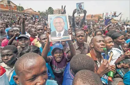  ?? Photo: Isaac Kasamani/AFP ?? Screen test: Supporters of Ugandan opposition leader Kizza Besigye. For the first time, the country is going to use fingerprin­t scanners to verify voters during the elections on Thursday.