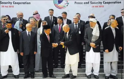  ?? Rahmat Gul ?? The Associated Press Indonesian Vice President Muhammad Jusuf Kalla, center left, and Afghan President Ashraf Ghani, center right, shake hands after a group photo with delegates during the 2nd Kabul Process conference at the Presidenti­al Palace...