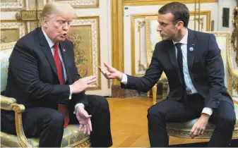  ?? Saul Loeb / AFP / Getty Images ?? President Trump and French President Emmanuel Macron exchange views in Paris on Saturday. Trump blasted Macron in a tweet after Macron denounced nationalis­m last weekend.