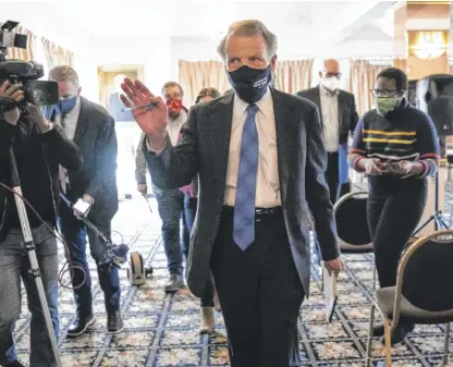  ?? ASHLEE REZIN/SUN-TIMES FILE ?? Former House Speaker Michael Madigan walks away from reporters after a committee hearing in 2021 to decide who would take over the House seat that Madigan had held since 1971.