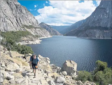  ?? DINO VOURNAS ?? The Wapama Falls above Yosemite’s Hetch Hetchy Reservoir takes hikers on a 2 1⁄2-mile trek to the waterfall. A Berkeley environmen­tal group is continuing its court battle to drain the reservoir.