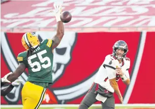  ?? USA TODAY SPORTS ?? Buccaneers quarterbac­k Tom Brady, right, throws a pass against the Packers in Tampa.