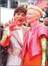  ?? (AP/Brynn Anderson) ?? Timothee Chalamet (left) and Tilda Swinton pose July 12 for photograph­ers upon arrival at the premiere of “The French Dispatch” at the film festival.