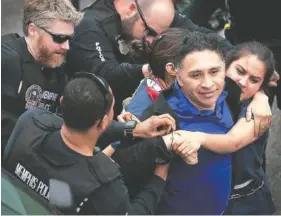  ?? AP PHOTO/JIM WEBER ?? Memphis police arrest Spanish-language reporter Manuel Duran on April 3, 2018, during an immigratio­n protest in Memphis. Duran, who has been facing deportatio­n since his arrest 15 months ago, was released from custody on July 11 as his case proceeds.