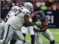  ?? BOB LEVEY — GETTY IMAGES, FILE ?? J.J. Watt (99), then with the Texans, is blocked by Trent Brown (77) during the first quarter of an Oct. 27 game between the Texans and Raiders at NRG Stadium in Houston.