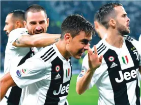  ??  ?? Juventus’ Paulo Dybala, centre, celebrates with his teammates after scoring his team’s first goal during the match between Juventus and Cagliari Photo: AP