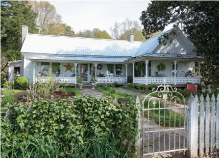  ??  ?? The Hugheses’ historic vernacular Victorian contains many of its original features, including gingerbrea­d millwork, plateglass windows and pine doors. The term “vernacular” refers to a home that is relatively plain in constructi­on but embellishe­d with decorative trim.