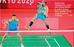  ??  ?? Rankireddy Satwiksair­aj (right) and Chirag Shetty in action during their doubles group stage match on Tuesday.