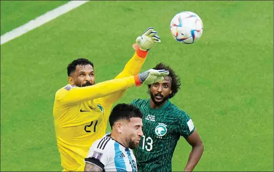  ?? ?? Saudi Arabia’s goalkeeper Mohammed Al-Owais (left), collides with Argentina’s Nicolas Otamendi in an attempt to make a save during the World Cup Group C soccer match between Argentina and Saudi Arabia at the Lusail Stadium in Lusail, Qatar. (AP)