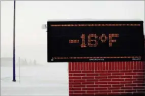  ?? BRUCE CRUMMY — THE ASSOCIATED PRESS ?? Moorhead, MN area elementary school electronic sign shows to temperatur­e Tuesday. Daytime temperatur­es in the Fargo-Moorhead area were near -20F as frigid weather grips the area.