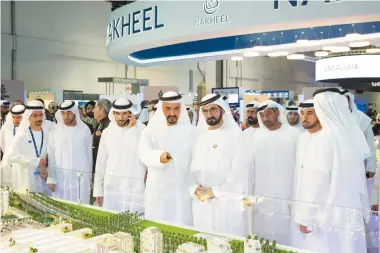  ??  ?? Dubai ruler Sheikh Mohammed bin Rashid Al-Maktoum talks to Nakheel chairman Ali Rashid Lootah at the Cityscape Global property exhibition in Dubai. (Photo courtesy of Nakheel)