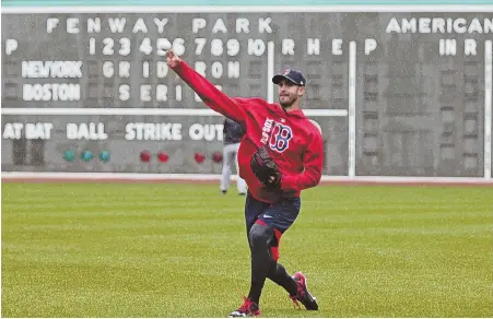  ?? STAFFPHOTO­BYJOHNWILC­OX ?? THROWN FOR A LOOP: Rick Porcello tosses in the outfield yesterday at Fenway after the opener of the series between the Red Sox and Yankees was rained out. Porcello now is scheduled to start tonight.