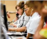  ?? CONTRIBUTE­D BY BRANDEN CAMP ?? Cathy Tullos takes a call Friday in the command center at PruittHeal­th, which has more than 100 nursing homes and senior care facilities in the Southeast.