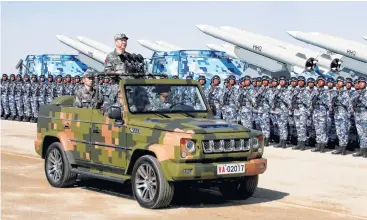  ?? Li Tao / Xinhua via AP ?? Chinese President Xi Jinping inspects troops of the People’s Liberation Army during a military parade Sunday to commemorat­e the 90th anniversar­y of the founding of the PLA at a training base in Inner Mongolia.