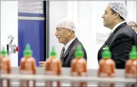 ?? LEOJARZOMB / SAN GABRIELVAL­LEY TRIBUNE ?? Texas state Rep. Jason Villalba (right), ofDallas, tours the Huy Fong Foods Inc. manufactur­ing plant, maker of Sriracha hot sauce, with founder and CEODavid Tran in Irwindale, Calif., on Monday.