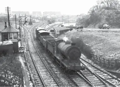  ?? W A C Smith/Transport Treasury ?? Viewed from the road overbridge at Craigleith station, looking north, Reid ‘J37’ class 0-6-0 No 64612 passes Craigleith Junction with a goods duty from either Granton or Leith on 25 January 1958. Despite its NBR heritage as ‘88’ series No 402 of January 1920, the locomotive was based at Dalry Road engine shed (ex-CR) at this time. Beyond the signal box is the diverging, singled and shortened Barnton branch of 1894 – it was truncated at Davidson’s Main from 7 May 1951 upon the loss of passenger services. On the right, a lorry climbs up to Queensferr­y Road from Craigleith quarry or the small goods yard sited to capitalise on its traffic. Although the pick-up goods is short, it is a Saturday, and the yard is clearly in use, but only until 1 June 1960. On the horizon, new houses are part of a massive transforma­tion for this location since the railway here first opened through to Granton for goods-only operations back in August 1861.