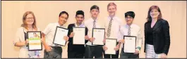  ??  ?? ■ The team from Roundhill College, Thurmaston, which won the Science Detectives Challenge, accepts its certificat­es and prizes with science teacher Bethany Davenport, from Nicky Morgan MP.