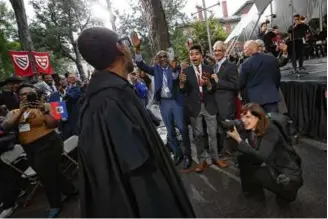  ?? SUZANNE KREITER/GLOBE STAFF ?? Harvard President Claudine Gay was greeted by her son, Costa, and husband, Christophe­r Afendulis, as she processed to her inaugurati­on.