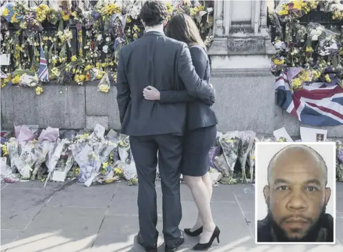  ??  ?? 0 A couple look at floral tributes to the victims of the Westminste­r terrorist attack by Khalid Masood, inset, outside Parliament