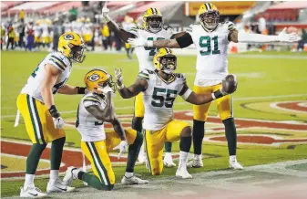  ?? Photos by Scott Strazzante / The Chronicle ?? Above, Green Bay’s Za’Darius Smith ( 55) celebrates his sack, forced fumble and recovery. Below, Davante Adams finishes off a 49yard reception against 49ers’ Marcell Harris.