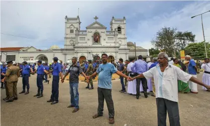  ?? Photograph: Rohan Karunarath­ne/AP ?? ‘Our small island nation had suffered enough.’ Soldiers secure the area around St Anthony’s shrine in Colombo on Sunday.