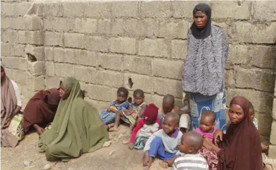 ??  ?? In this undated file photo, women and children are seen after they were removed from a suspected Boko Haram hideout during a military raid at Sabuwar Gandu neighbourh­ood in Kano.