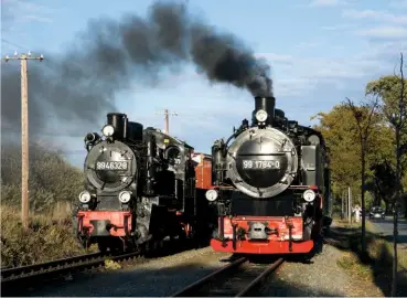  ?? TONY STREETER ?? Old and older, largish and small… well tank No. 99.4632 has almost 40 years on 2-10-2T No. 99.1784, which rolls past the 1914-built veteran at Posewald loop in October 2018.(Note – trackside shots taken in the presence of a Ruegensche Baederbahn representa­tive).