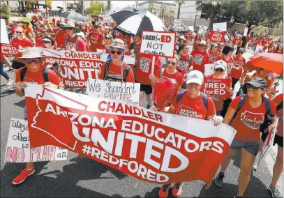  ?? Ross D. Franklin ?? The Associated Press Thousands march to the Arizona Capitol in Phoenix on Thursday to demand greater teacher pay and school funding.