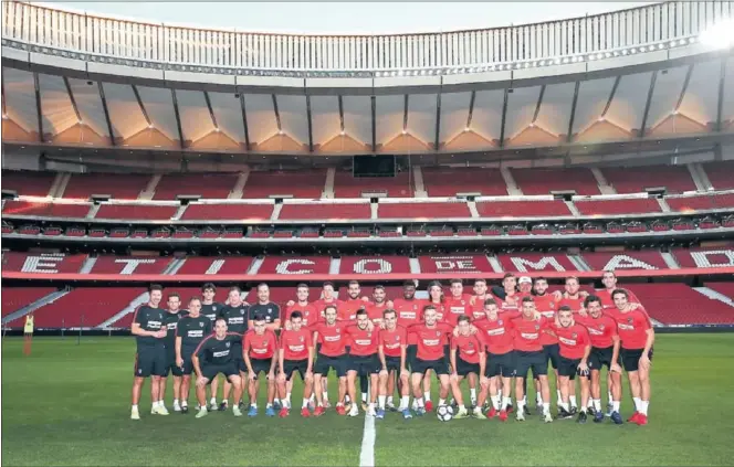  ??  ?? FOTO DE FAMILIA. Los jugadores del Atlético posan en el Wanda Metropolit­ano en la sesión de entrenamie­nto de ayer, la primera en el nuevo estadio.