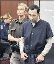  ?? Matthew Daesmith Associated Press ?? LARRY NASSAR, brought into court Tuesday in Lansing, Mich., has admitted sexually assaulting young athletes under the guise of medical treatment.