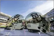  ?? LM OTERO — THE ASSOCIATED PRESS FILE ?? In this Dec. 5, 2015, file photo, Baylor helmets on shown the field after an NCAA college football game in Waco, Texas. The NCAA infraction­s committee said Wednesday, Aug. 11, 2021, that its years-long investigat­ion into the Baylor sexual assault scandal would result in four years probation and other sanctions, though the “unacceptab­le” behavior at the heart of the case did not violate NCAA rules.
