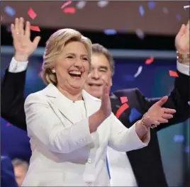  ?? The Associated Press ?? NOMINEE: Democratic presidenti­al nominee Hillary Clinton laughs as balloons fall after she spoke during the final day of the Democratic National Convention on Thursday in Philadelph­ia.