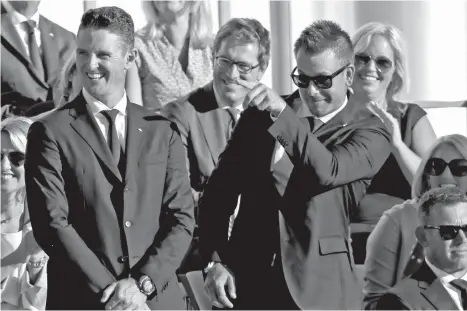  ?? AP Photo/David J. Phillip ?? EUROPE'S Justin Rose and Henrik Stenson react after it was announced they were playing United States' Jordan Spieth and Patrick Reed in Friday's first round during the opening ceremony for the Ryder Cup golf tournament Thursday, Sept. 29, 2016, at...