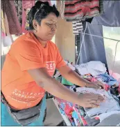  ?? PICTURE: SIBONELO NGCOBO ?? Cindy Parsotham packs clothing on to a table under her gazebo.