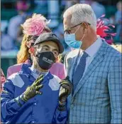  ?? Skip Dickstein / Special to the Times Union ?? Jockey John Velazquez discusses the race with trainer Todd Pletcher after winning the 147th running of the Kentucky Oaks on
Malathaat at Churchill Downs on April 30.