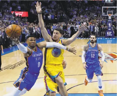  ?? Sue Ogrocki / Associated Press ?? Oklahoma City’s Russell Westbrook goes past Klay Thompson en route to the basket and a game-high 44 points. The Warriors held the rest of the Thunder to 29.9 percent shooting.