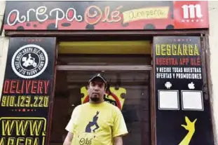  ??  ?? MADRID: Venezuelan businessma­n Edgar Rodriguez poses outside his restaurant called “Arepa Ole”. —AFP
