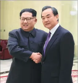  ?? PHOTO BY XINHUA ?? Kim Jong-un, top leader of the Democratic People’s Republic of Korea, meets with State Councilor and Foreign Minister Wang Yi in Pyongyang on Thursday. Wang says Beijing supports the Korean Peninsula’s shift from armistice to peace as well as...