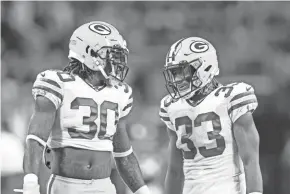  ?? BRAD REMPEL/USA TODAY SPORTS ?? Running backs Jamaal Williams, left, and Aaron Jones warm up before Monday’s game. Williams hurt his shoulder in the third quarter.