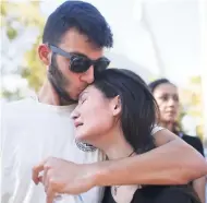  ?? AP ?? Students Nicole Baltzer(right) and Alex Debs, embrace yesterday in Parkland, Florida, during a community vigil for the victims of the shooting at Marjory Stoneman Douglas High School. Nikolas Cruz, a former student, was charged with 17 counts of...