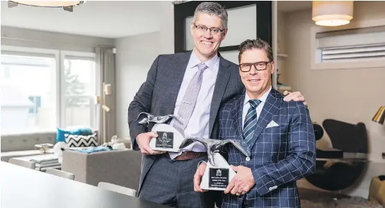  ?? DON MOLYNEAUX ?? Brookfield Residentia­l chief operating officer Trent Edwards and senior vice-president Allan Klassen pose with their SAM awards, which feature a stylized bird.