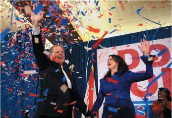  ?? AP PHOTO ?? Democratic candidate for U.S. Senate Doug Jones and his wife Louise wave to supporters before speaking on Tuesday in Birmingham, Ala. Jones defeated Republican Roy Moore, a one-time GOP pariah who was embraced by the Republican Party and the president...